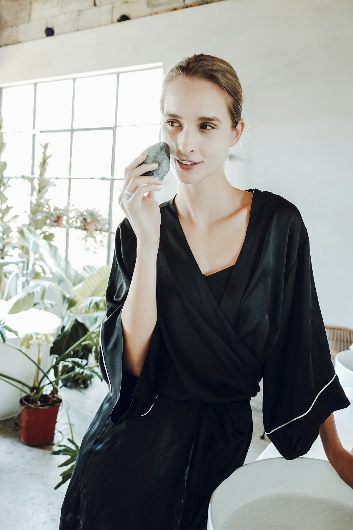 A robe draped across a chair in a light-filled studio